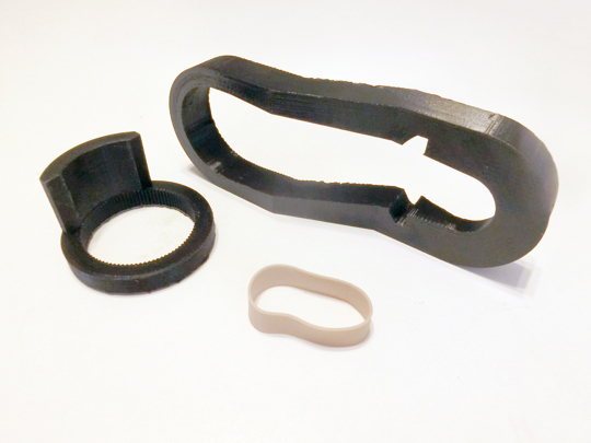 Three components. A 3D-printed lever in the shape of a elongated loop. A 3D-printed ring the size of a doorknob with an extrusion that fits into a notch on the lever. A rubber band.